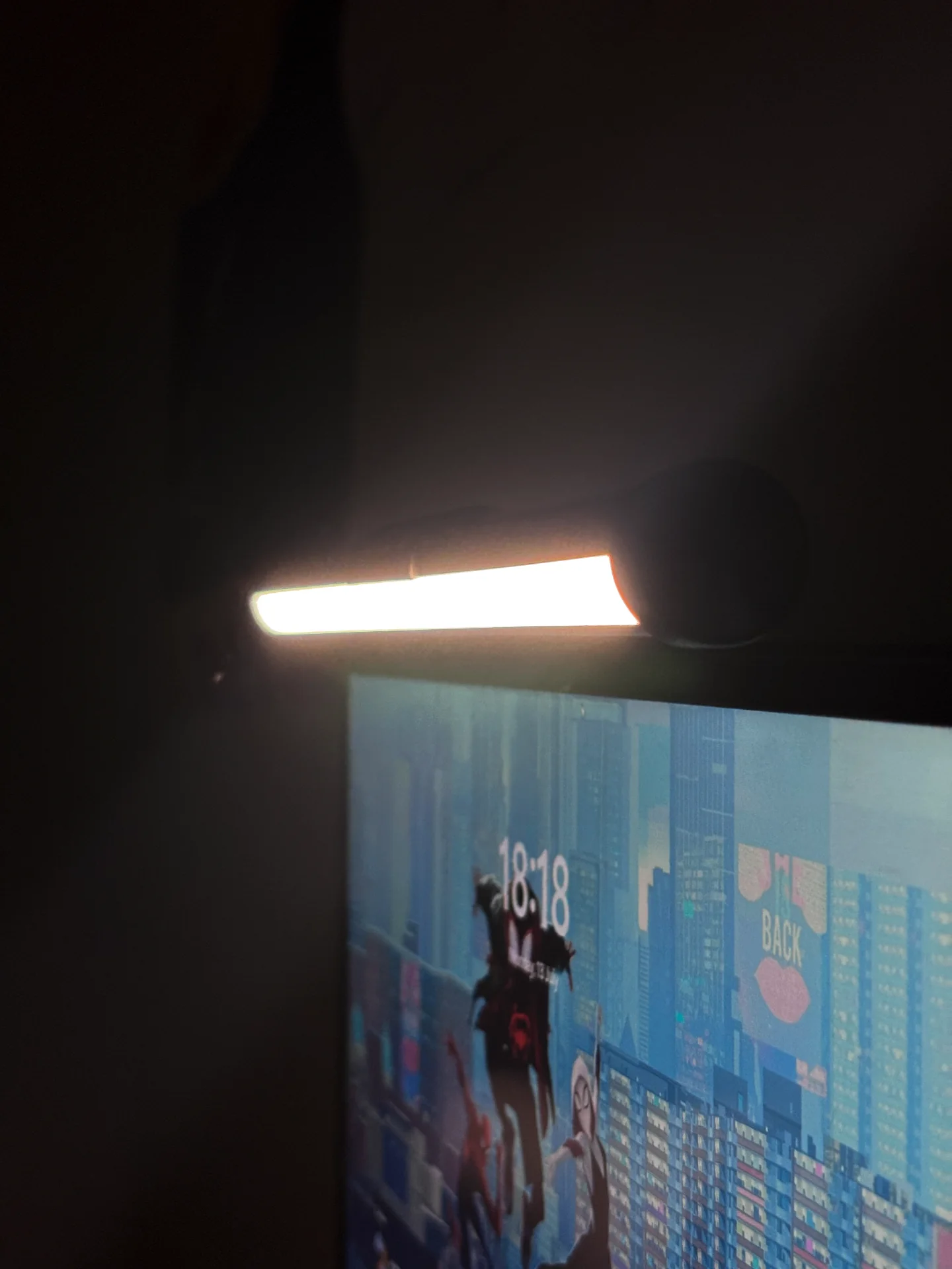 Desklyne monitor light bar glowing above a curved monitor