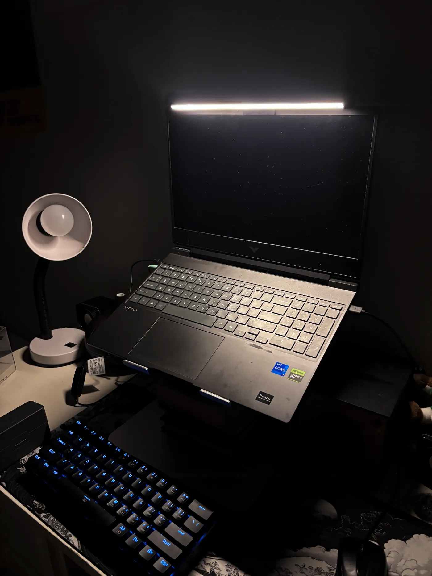 Desklyne monitor light bar illuminating a laptop workspace
